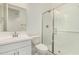 Well-lit bathroom featuring a glass-enclosed shower, a sink, and a toilet at 18189 W Hess St, Goodyear, AZ 85338