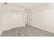 A bright bedroom features a closet with sliding doors and plush gray carpeting at 18189 W Hess St, Goodyear, AZ 85338