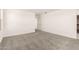 Bright bedroom with neutral carpet, white walls, and an open doorway at 18189 W Hess St, Goodyear, AZ 85338