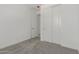 Bright bedroom featuring plush gray carpeting, a closet with sliding doors and a doorway at 18189 W Hess St, Goodyear, AZ 85338