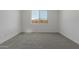 Bedroom with carpeted floors and a window at 18189 W Hess St, Goodyear, AZ 85338