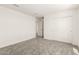 Bedroom featuring carpet flooring, closet doors, and access to a connected room at 18189 W Hess St, Goodyear, AZ 85338