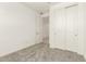 Bedroom featuring carpet flooring, closet doors, and access to a connected room at 18189 W Hess St, Goodyear, AZ 85338