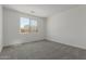Bright bedroom with carpeted floors and a large window at 18189 W Hess St, Goodyear, AZ 85338
