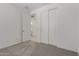 Bedroom featuring neutral carpet, slider closet, and ensuite bathroom at 18189 W Hess St, Goodyear, AZ 85338