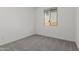 Bedroom featuring neutral carpet, baseboard trim and a window at 18189 W Hess St, Goodyear, AZ 85338