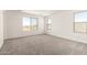 Spacious bedroom with neutral carpet and windows that provide lots of natural light at 18189 W Hess St, Goodyear, AZ 85338
