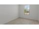 Well-lit bedroom featuring light tile flooring and a window with outside views at 18189 W Hess St, Goodyear, AZ 85338