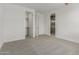 This bedroom features neutral carpet, walk-in closet, and ensuite bathroom at 18189 W Hess St, Goodyear, AZ 85338