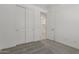 Bedroom featuring neutral carpet, slider closet, and ensuite bathroom at 18189 W Hess St, Goodyear, AZ 85338