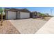 Wide driveway featuring block pavers and access to the home's three-car garage at 18189 W Hess St, Goodyear, AZ 85338
