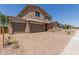 Beautiful home boasting a large driveway, landscaping, and three-car garage at 18189 W Hess St, Goodyear, AZ 85338