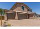 Two-story home with a 3-car garage and a well-manicured paver driveway at 18189 W Hess St, Goodyear, AZ 85338