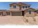 Attractive two-story home featuring a tile roof, three-car garage, and low-maintenance desert landscaping at 18189 W Hess St, Goodyear, AZ 85338