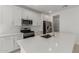 Modern kitchen with stainless steel appliances, white cabinets, and an island with a sink at 18189 W Hess St, Goodyear, AZ 85338