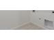 Well-lit laundry room featuring tiled flooring and washer/dryer hookups at 18189 W Hess St, Goodyear, AZ 85338