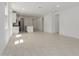 Bright, open-concept living room with tiled floors and backyard access at 18189 W Hess St, Goodyear, AZ 85338