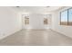 Bright, spacious living room featuring tile floors, recessed lighting and windows for plenty of natural light at 18189 W Hess St, Goodyear, AZ 85338