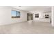 Open-concept living space adjacent to kitchen with tile flooring, recessed lights, and lots of natural light at 18189 W Hess St, Goodyear, AZ 85338