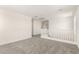 A bright loft space features plush gray carpeting and white banisters at 18189 W Hess St, Goodyear, AZ 85338