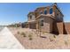 Charming home with rock landscaping, sidewalk, and a three-car garage at 18189 W Hess St, Goodyear, AZ 85338