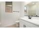 Modern bathroom with single sink vanity, black faucet, and black towel rack at 18195 W Hess St, Goodyear, AZ 85338