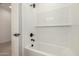 Clean white bathtub and shower with subway tile and black fixtures at 18195 W Hess St, Goodyear, AZ 85338