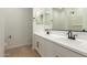 Bathroom featuring double sinks, white cabinets, and a tile floor at 18195 W Hess St, Goodyear, AZ 85338
