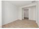 Bright bedroom with tile flooring, a door, and a glimpse into another room at 18195 W Hess St, Goodyear, AZ 85338