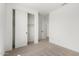 Neutral carpeted bedroom featuring sliding closet doors at 18195 W Hess St, Goodyear, AZ 85338