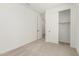 Cozy bedroom featuring sliding closet, carpeted flooring, and fresh white walls at 18195 W Hess St, Goodyear, AZ 85338
