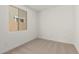 Bedroom featuring carpet flooring, white walls, and a bright window with neighborhood view at 18195 W Hess St, Goodyear, AZ 85338