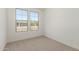 Comfortable bedroom with carpet flooring, white walls, and large window with neighborhood views at 18195 W Hess St, Goodyear, AZ 85338