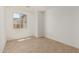 This bright bedroom features tile floors and a window overlooking the neighborhood at 18195 W Hess St, Goodyear, AZ 85338