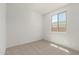 Bedroom featuring neutral carpet and a window view of the neighboring house at 18195 W Hess St, Goodyear, AZ 85338