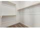 Walk-in closet with carpeted flooring and wooden racks and shelving at 18195 W Hess St, Goodyear, AZ 85338