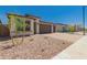 Attractive single-Gathering home boasts stone accents, desert landscaping, and a brick paver driveway leading to a garage at 18195 W Hess St, Goodyear, AZ 85338