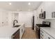 Modern kitchen featuring white cabinets, stainless steel appliances, and a large island with bar seating at 18195 W Hess St, Goodyear, AZ 85338