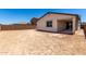Rear view of home showcasing backyard, covered patio, and desert landscape at 18204 W Hess St, Goodyear, AZ 85338