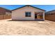 Rear of house with patio featuring a spacious backyard and privacy wall at 18204 W Hess St, Goodyear, AZ 85338