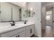 Bathroom featuring dual sinks, dark fixtures, with tile flooring at 18204 W Hess St, Goodyear, AZ 85338