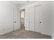 Bedroom with white walls, carpet, and closet, with an open door to laundry area at 18204 W Hess St, Goodyear, AZ 85338