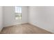 Bright, minimalist bedroom featuring modern tile flooring, fresh paint and ample natural light at 18204 W Hess St, Goodyear, AZ 85338