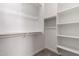A walk-in closet features multiple levels of shelving and a hanging rod at 18204 W Hess St, Goodyear, AZ 85338