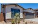 The home's exterior features desert landscaping, stone accents, blue shutters, and a paved driveway at 18204 W Hess St, Goodyear, AZ 85338