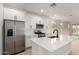 Bright, modern kitchen with stainless steel appliances, white cabinetry, and a center island perfect for entertaining at 18204 W Hess St, Goodyear, AZ 85338