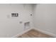 White laundry room with tile flooring, utility connections, and electrical outlets at 18204 W Hess St, Goodyear, AZ 85338