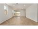 Spacious living room with tile floors, bright natural light, and sliding doors to the outdoor patio at 18204 W Hess St, Goodyear, AZ 85338