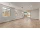 Bright, open living space with tile floors, large windows, and a sliding glass door for seamless indoor-outdoor living at 18204 W Hess St, Goodyear, AZ 85338