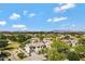 Overview of a picturesque neighborhood featuring neat homes, lush greenery, and community amenities under a sunny sky at 19820 E Reins Rd, Queen Creek, AZ 85142